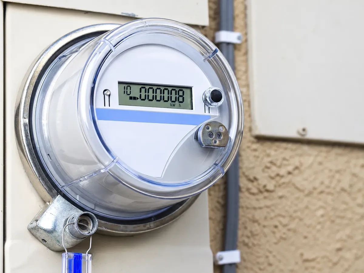 Electricity meter with digital display mounted on a wall